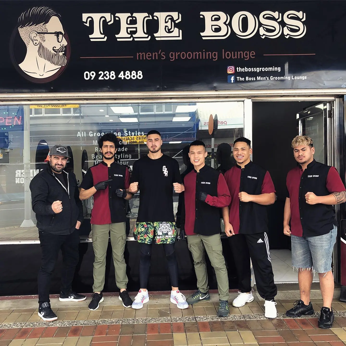 The Boss team standing outside the storefront