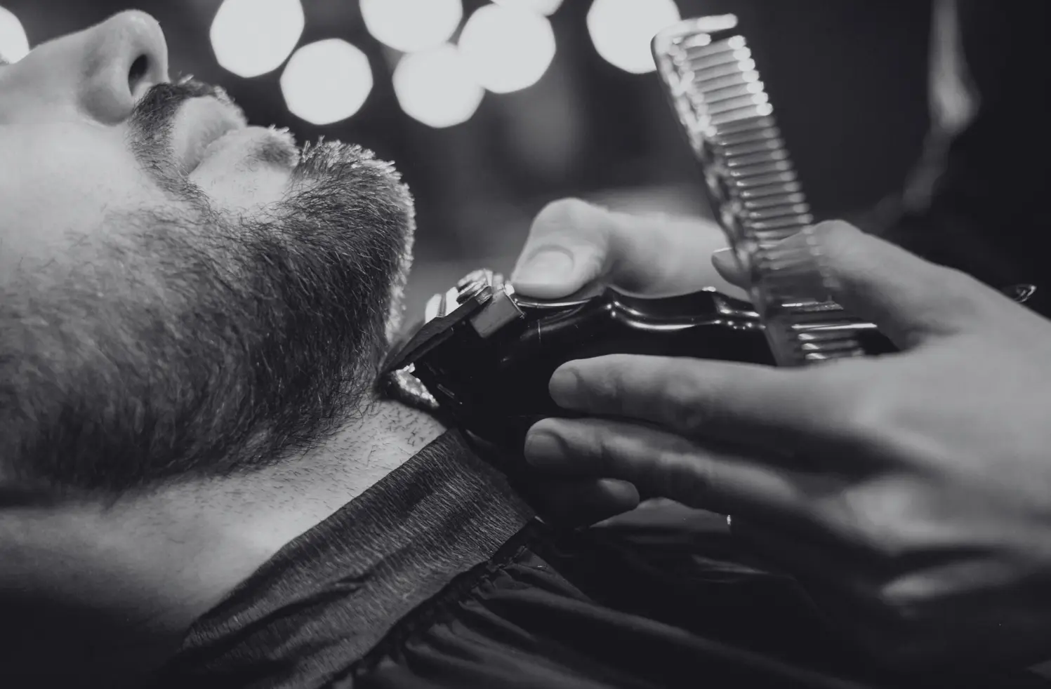 Beard trim with clippers and comb in black and white